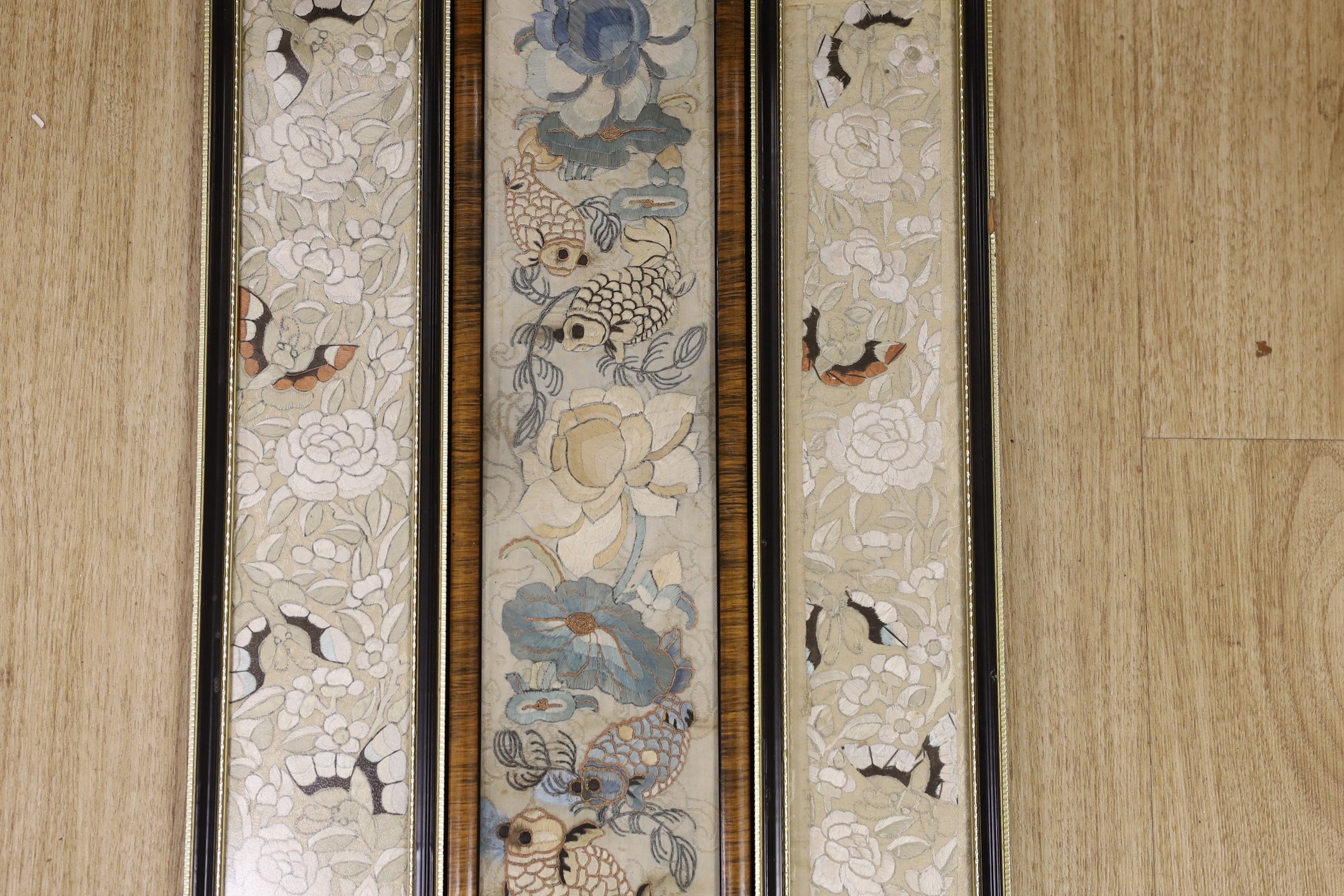 Three 19th century Chinese framed silk embroidered sleeve panels, largest 12 x 55cm